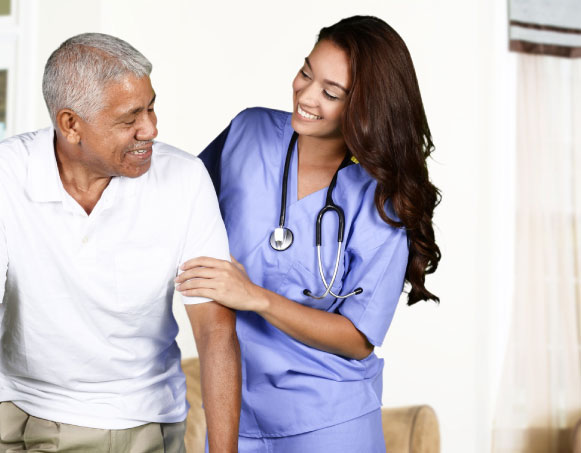 Image of a female nurse helping an older male patient walk